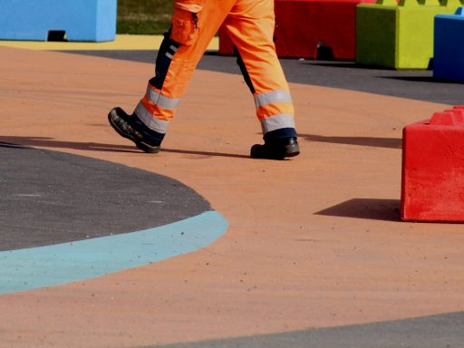 man in orange pants and black and white nike sneakers